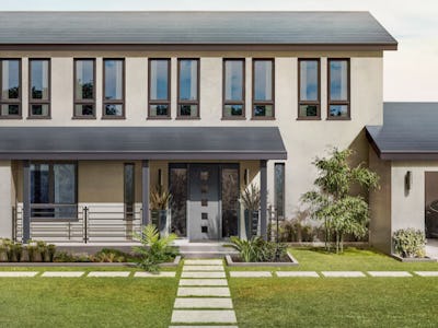 An image depicting a residence featuring a parked vehicle within the garage.