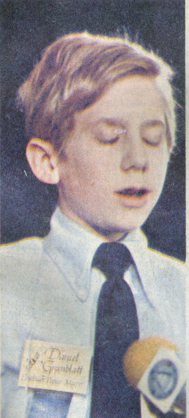 1984 Scripps National Spelling Bee Winner Daniel Greenblatt standing in front of the microphone.