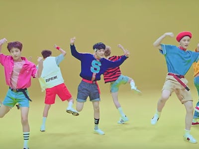 Members of NCT Dream dancing around on a yellow background