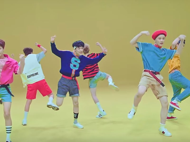 Members of NCT Dream dancing around on a yellow background