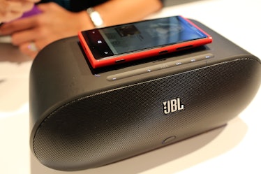 A Nokia Lumia 920 charging on top of a speaker at a 2012 event using inductive charging.