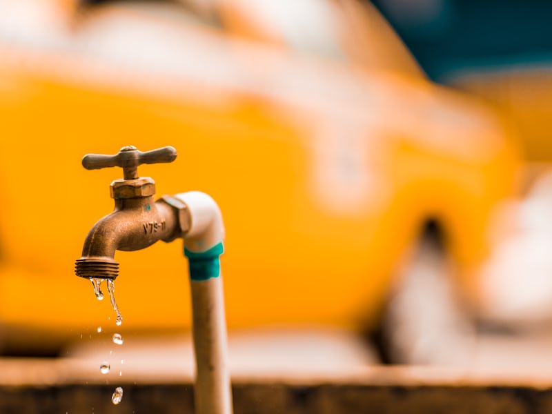 A small faucet with water with contaminants drops dripping from it that can cause Cancer