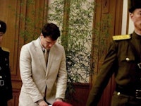 Otto Warmbier in a white suit during his arrest.
