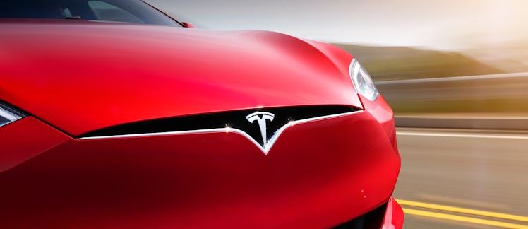 Tesla logo on a red Model S.