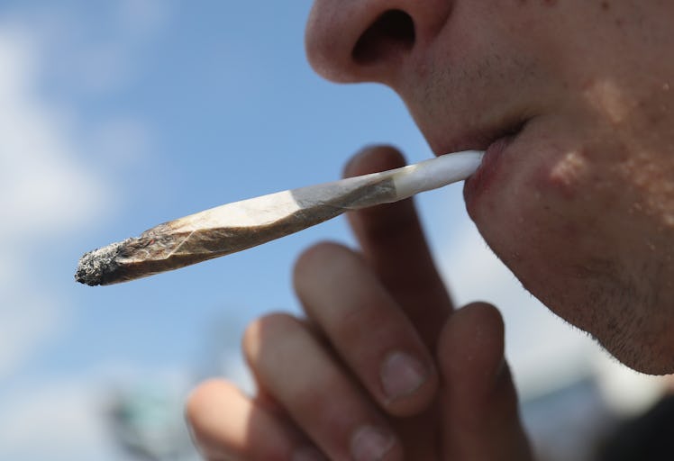 BERLIN, GERMANY - AUGUST 13: An activists smokes a marijuana joint prior to marching in the annual H...
