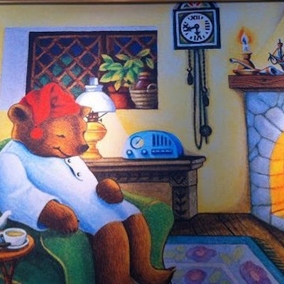 Celestial Seasonings bear sitting in a rocking chair in front of a cozy fireplace.