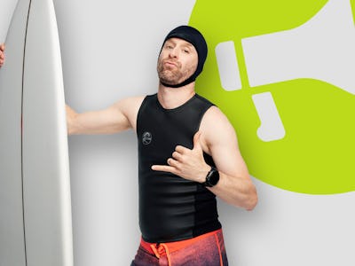 Jon Glaser posing with a white surfboard