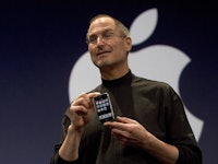 Steve Jobs holding an iPhone