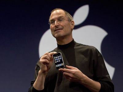 Steve Jobs holding an iPhone