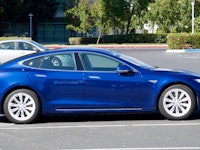 Blue Tesla car parked on the parking lot