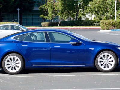 Blue Tesla car parked on the parking lot