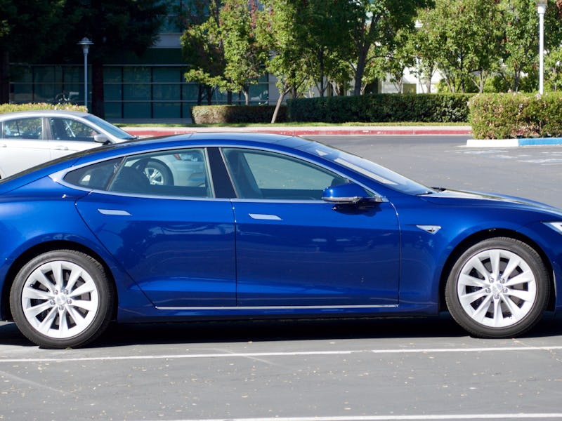 Blue Tesla car parked on the parking lot