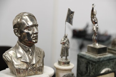 A bust of Adolf Hitler next to a statue depicting a Nazi soldier