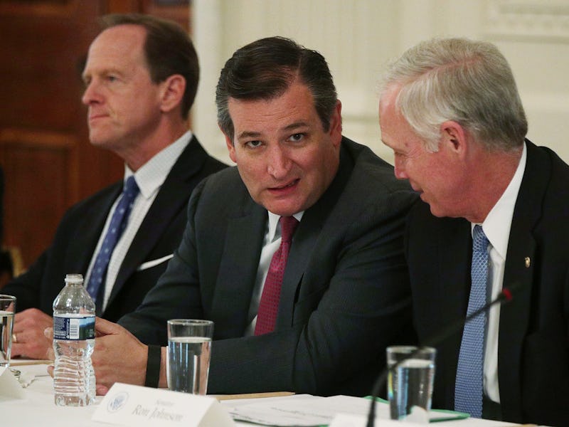Ted Cruz smirking at the camera during a meeting