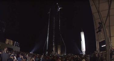 Elon Musk, standing underneath Starship Mk.1.