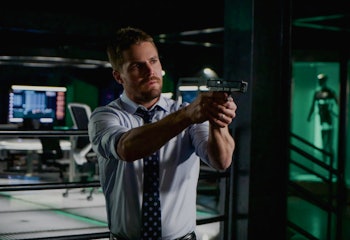 Stephen Amell holding a gun in Arrow