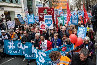 LONDON, ENGLAND - MARCH 04: Protesters carry banners and placards through central London during a de...