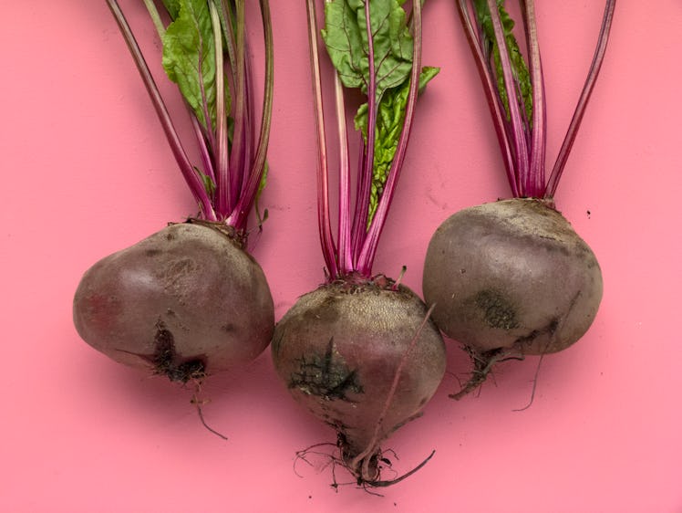 Three beets on a pink background