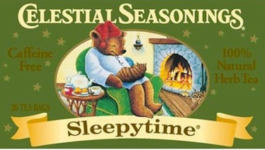 Celestial Seasonings sleepytime bear sleeping in a rocking chair with a cat in his lap in front of a...
