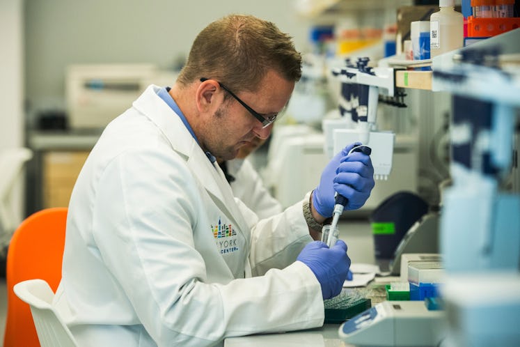 A researcher preparing a DNA sample in a lab