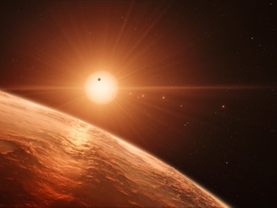 A shot of Earth in space with the Sun in the distance with 7 earth-like planets near it