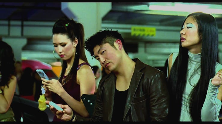 Drift King (D.K.) with two girls in a scene in "Fast and Furious: Tokyo Drift"