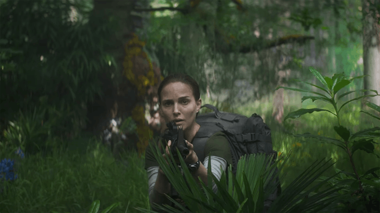 Natalie Portman holding a gun in a forest in 'Annihilation'