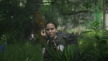 Natalie Portman holding a gun in a forest in 'Annihilation'