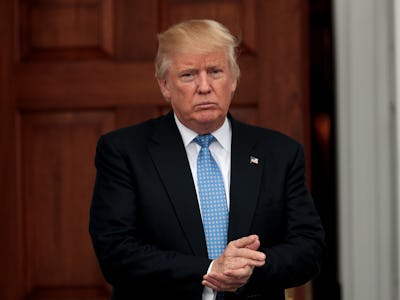 Donald Trump in a black suit, white shirt and blue tie