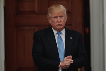 Donald Trump in a black suit, white shirt and blue tie