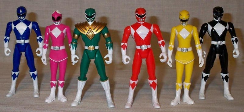 A blue, pink, green, red, yellow, and blue Power Rangers figure placed in a row
