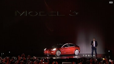 Elon Musk shows off the Tesla Model 3. 