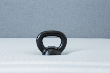 A 20-pound kettlebell placed on a Leesa mattress to show the sink and support (the average human hea...