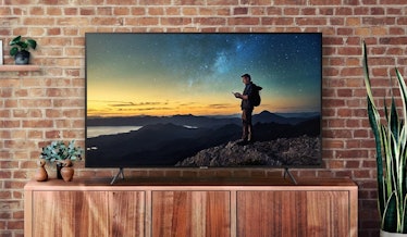 Smart Samsung 40NU7100 TV in front of a brick wall