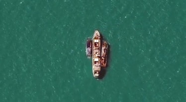 The WorldView-3 satellite captured views of a commercial fishing vessel accepting salve-caught cargo...