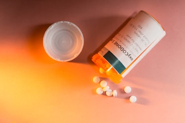 Oxycodone Prescription Bottle with Pills Spilling Out.