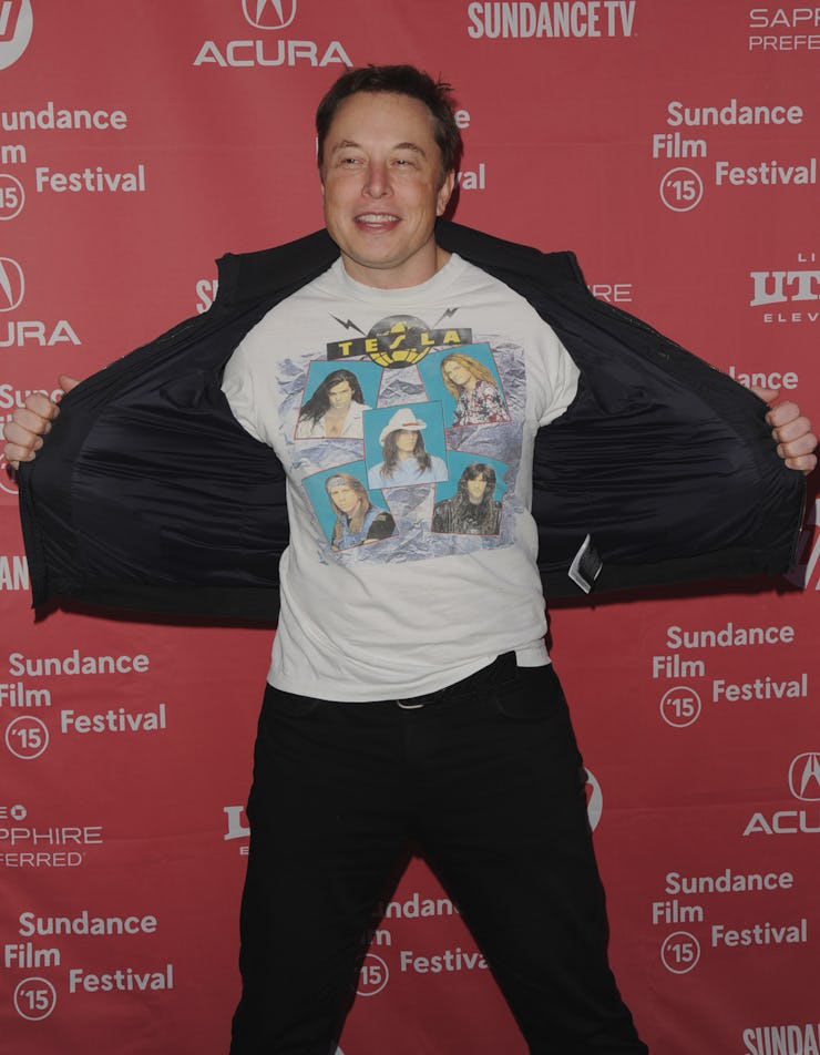 Elon Musk in a white shirt and black pants at an event