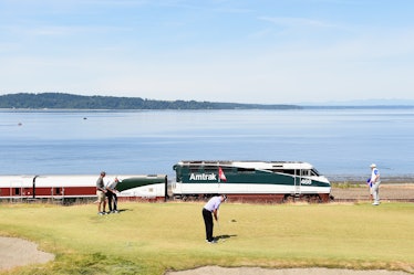 UNIVERSITY PLACE, WA - JUNE 15: An Amtrak train passes the 16th green during a practice round prior ...