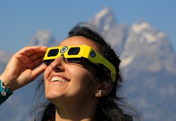 JACKSON, WY - AUGUST 21: A woman views the solar eclipse in the first phase of a total eclipse in Gr...