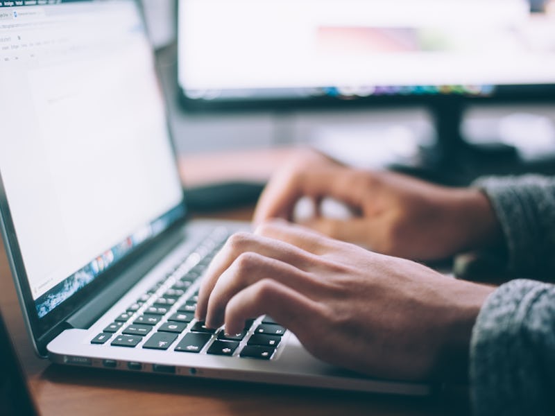 A person typing on a laptop and looking at game bundle specials