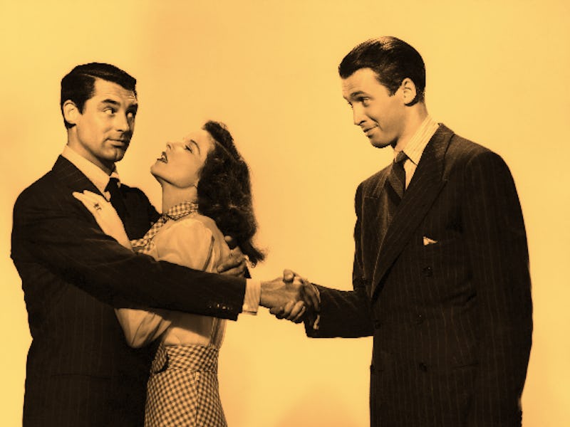 A polyamorous couple with a man hugging a woman and also holding the hand of another man