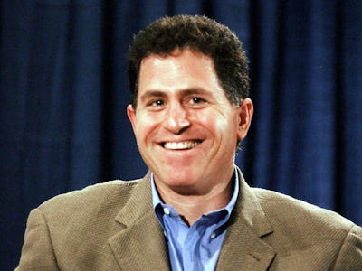 Michael Dell in a blue shirt and a beige blazer smiling 