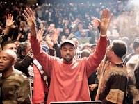 Kanye West in the middle of his audience crowd 