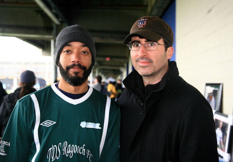 Wyatt Cenac and John Oliver posing for a photo together