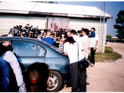 A screenshot from Making a Murderer Season 2 with a group of journalists around Steven Avery