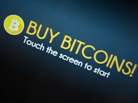 "Buy Bitcoins" text sign and Bitcoin logo
