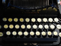 A close-up of the keyboard segment of an old typewriter machine