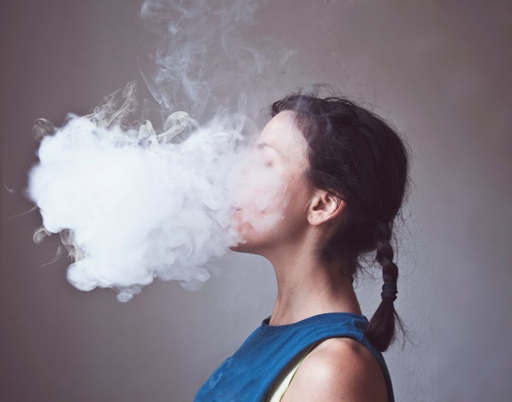 Woman smoking electronic cigarette creating cloud of vapor E-Cigarette | Electronic Cigarette | E-Ci...