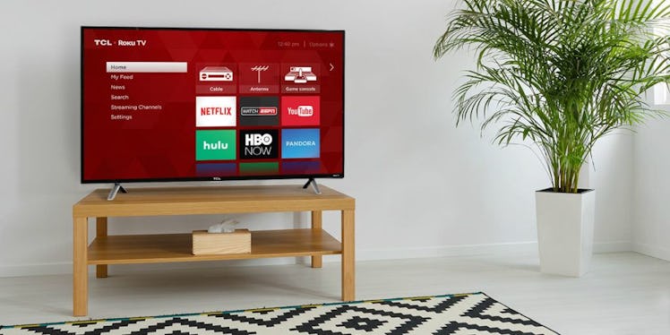 Smart TCL 32S327 TV on a wooden table in a living room