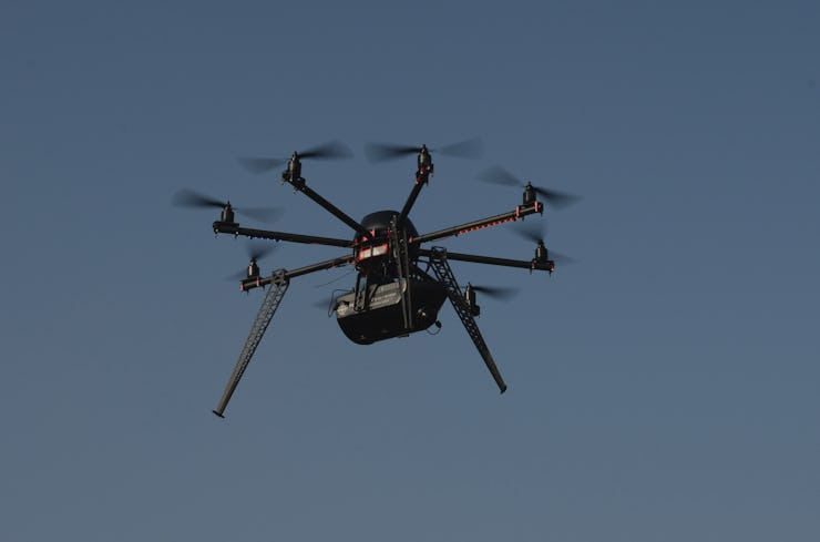 A black drone in air